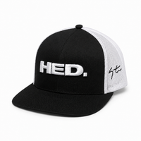 The HED. Trucker Snapback Hat – Black & White is an adjustable trucker snapback hat with HED. embroidered in large white letters on the front and a signature detail on the side of its white mesh back.