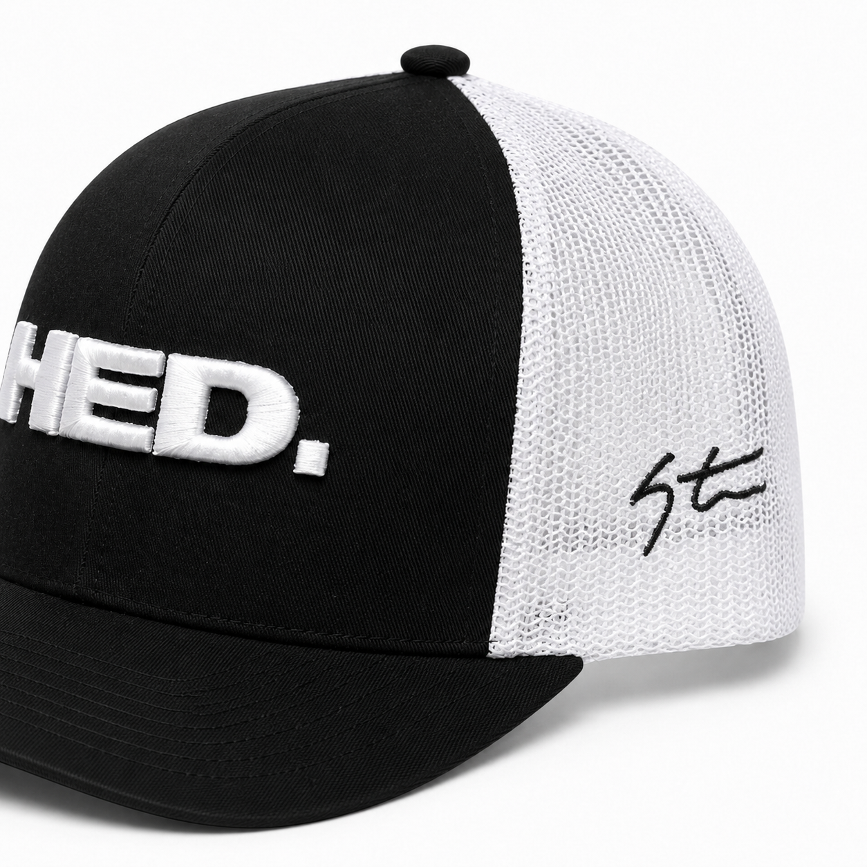 The HED. Trucker Snapback Hat – Black & White is an adjustable trucker hat featuring a black and white mesh design, “HED.” embroidered in large white letters on the front, and a bold black signature on the white mesh side.