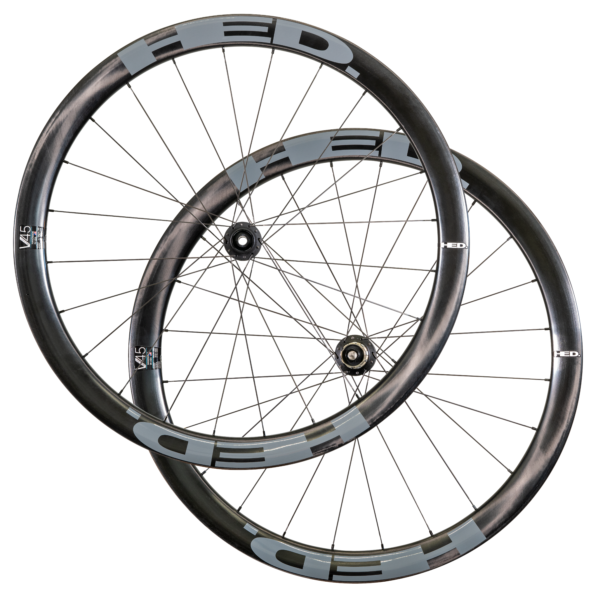 Two overlapping black and gray HED Vanquish V45 Carbon Aero wheels with thin spokes, visible hub mechanisms, and sleek aerodynamic rims are arranged against a white background, highlighting the advanced design of this premium carbon wheelset tailored for all-road riding.