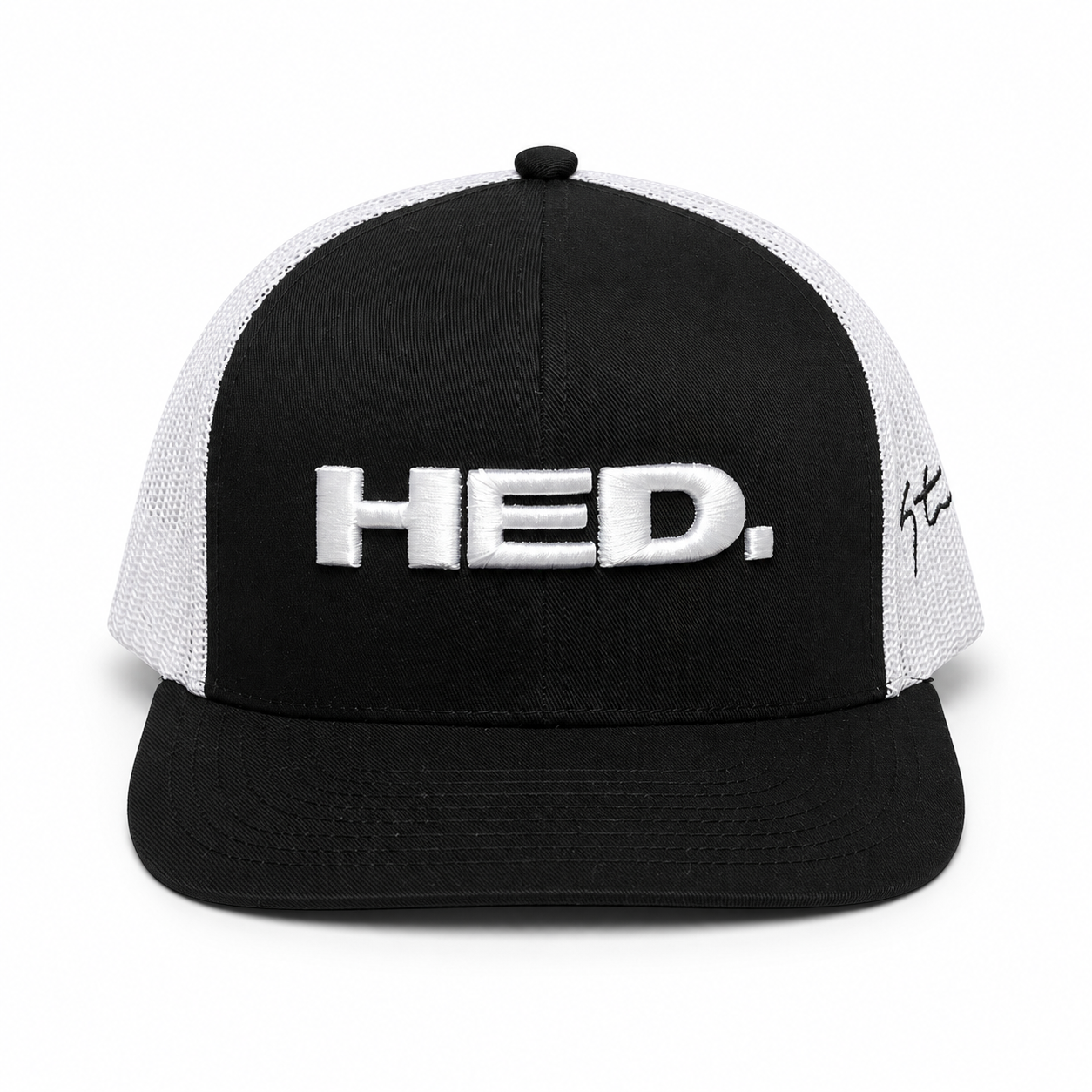The HED. Trucker Snapback Hat – Black & White is an adjustable black and white trucker hat, featuring “HED.” embroidered in white on the front and a signature on the left side panel.